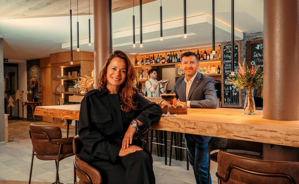Simone und Martin sitzen am Tisch in der Bar des Helmhotel