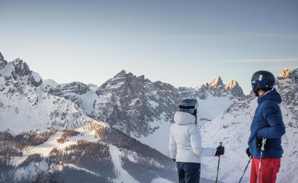 A man is skiing down a ski slope in the Drei Zinnen ski area
